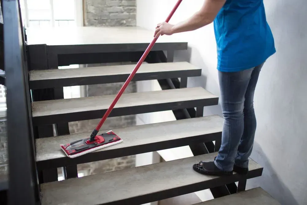 Person Mopping Concrete Stairs With a Red-handled Mop — Jamac Cleaning Services in Belmont, NSW