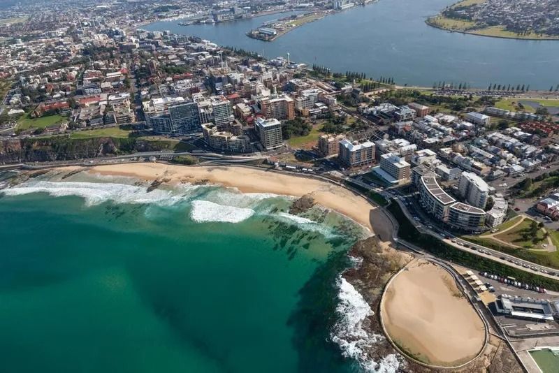 Aerial View of a Coastal Bay With Turquoise Water — Jamac Cleaning Services in Newcastle, NSW