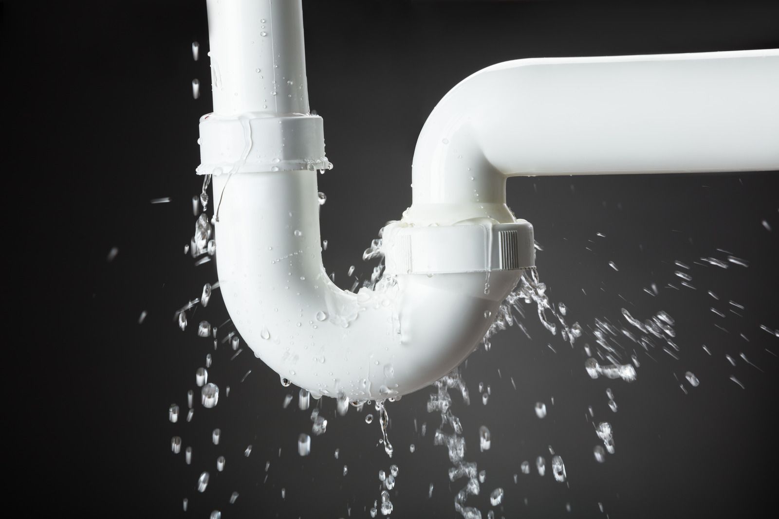 White PVC pipe leaking water.