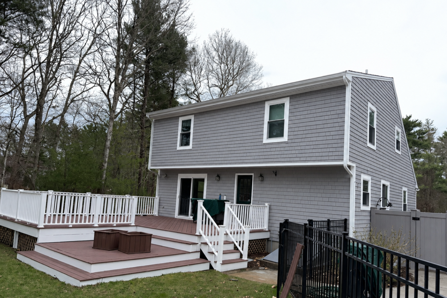 Exterior house painting with gray siding and white trim in Freetown, MA