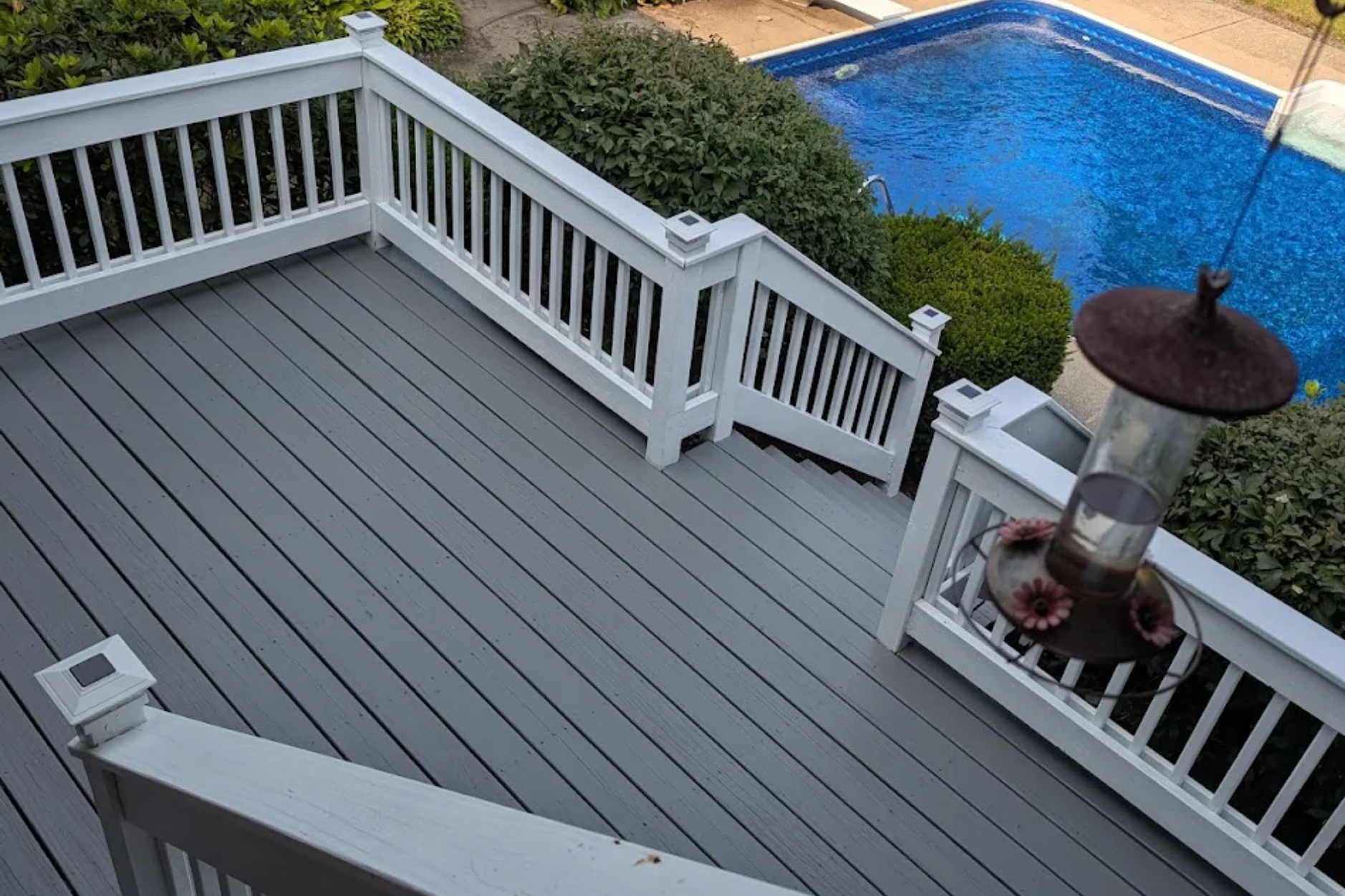 Gray painted deck boards with white painted railings
