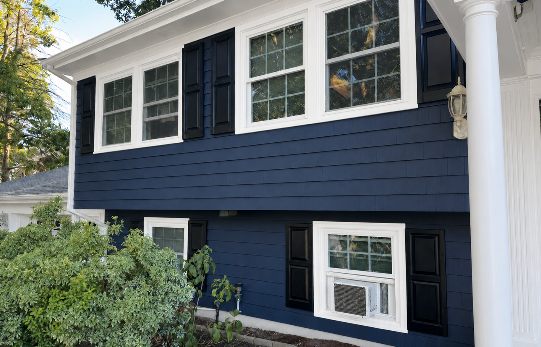 Blue-painted house exterior with white trim and shutters completed by PTG Painting in Plymouth, Massachusetts