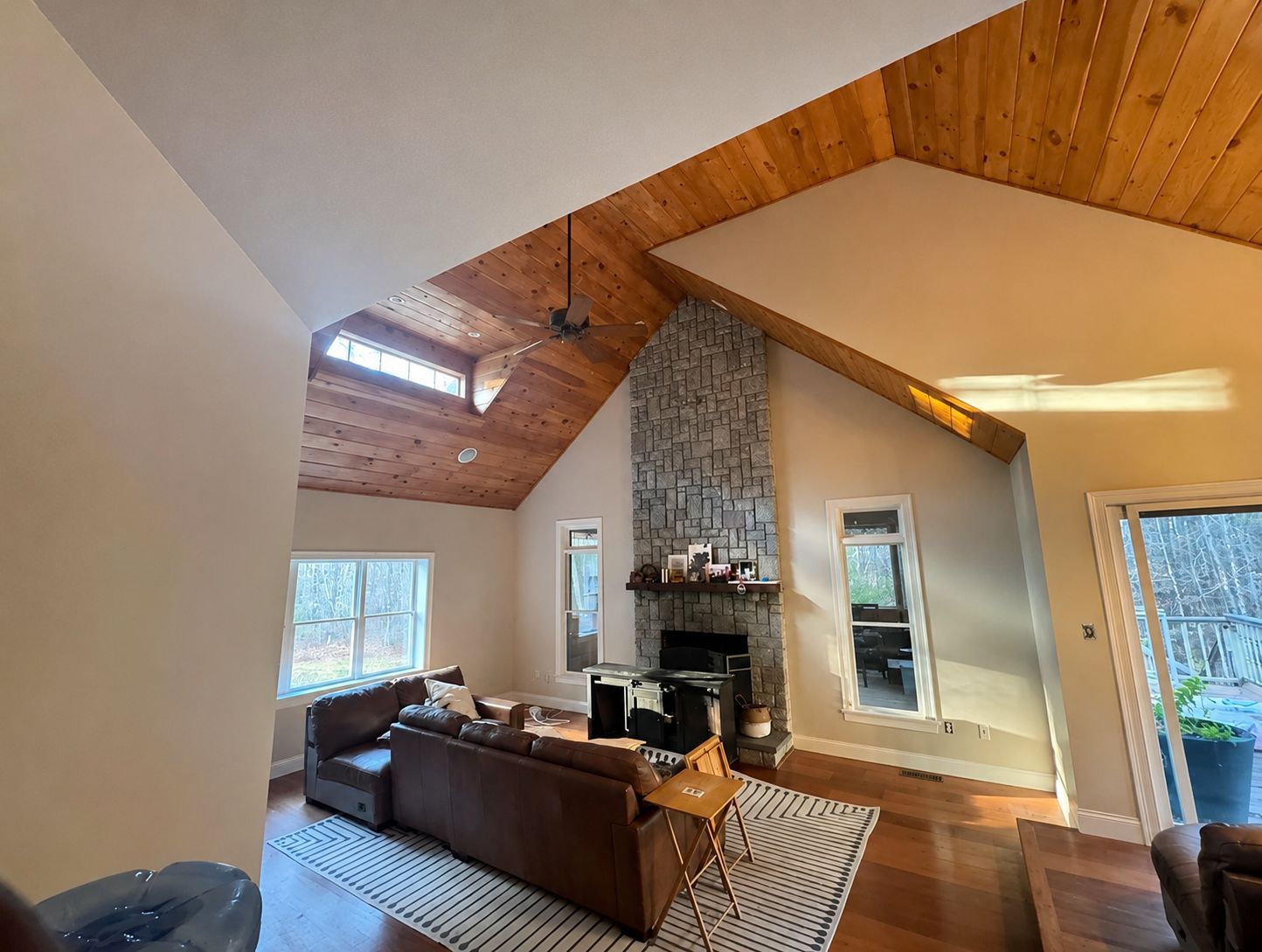 Professionally painted living room with vaulted wood ceiling and stone fireplace in Norton, Massachusetts
