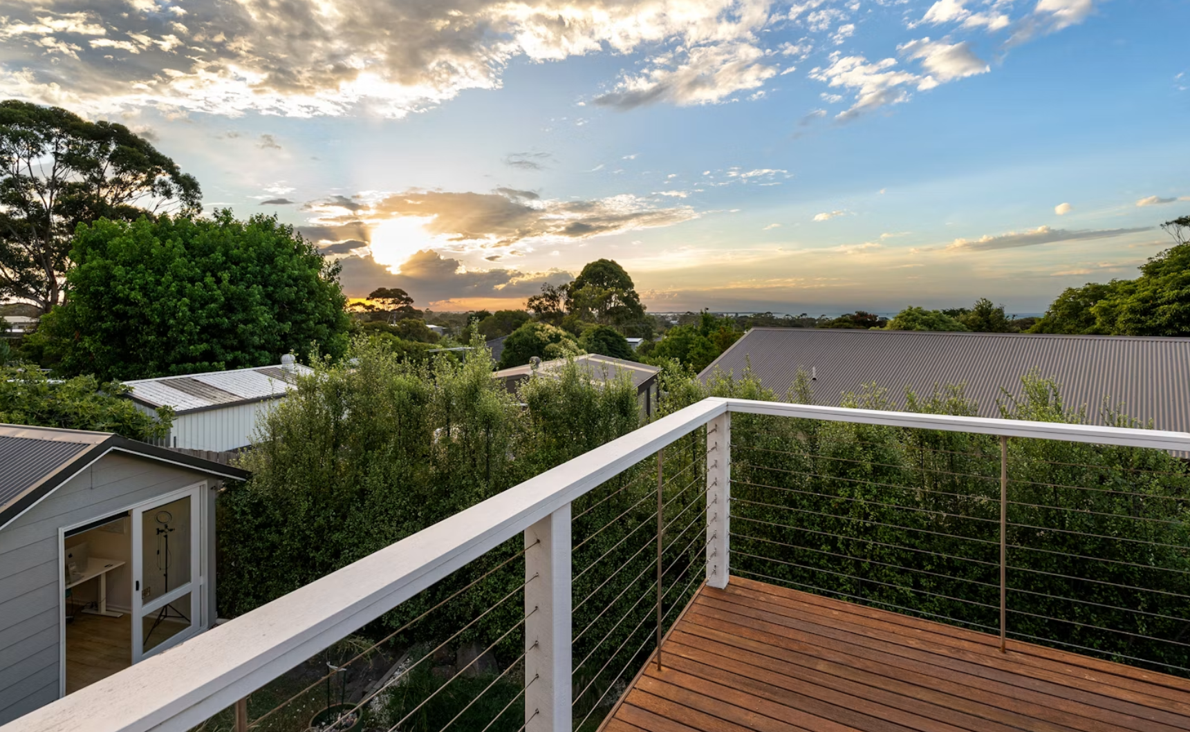 White painted deck railings with stained wood floorboards