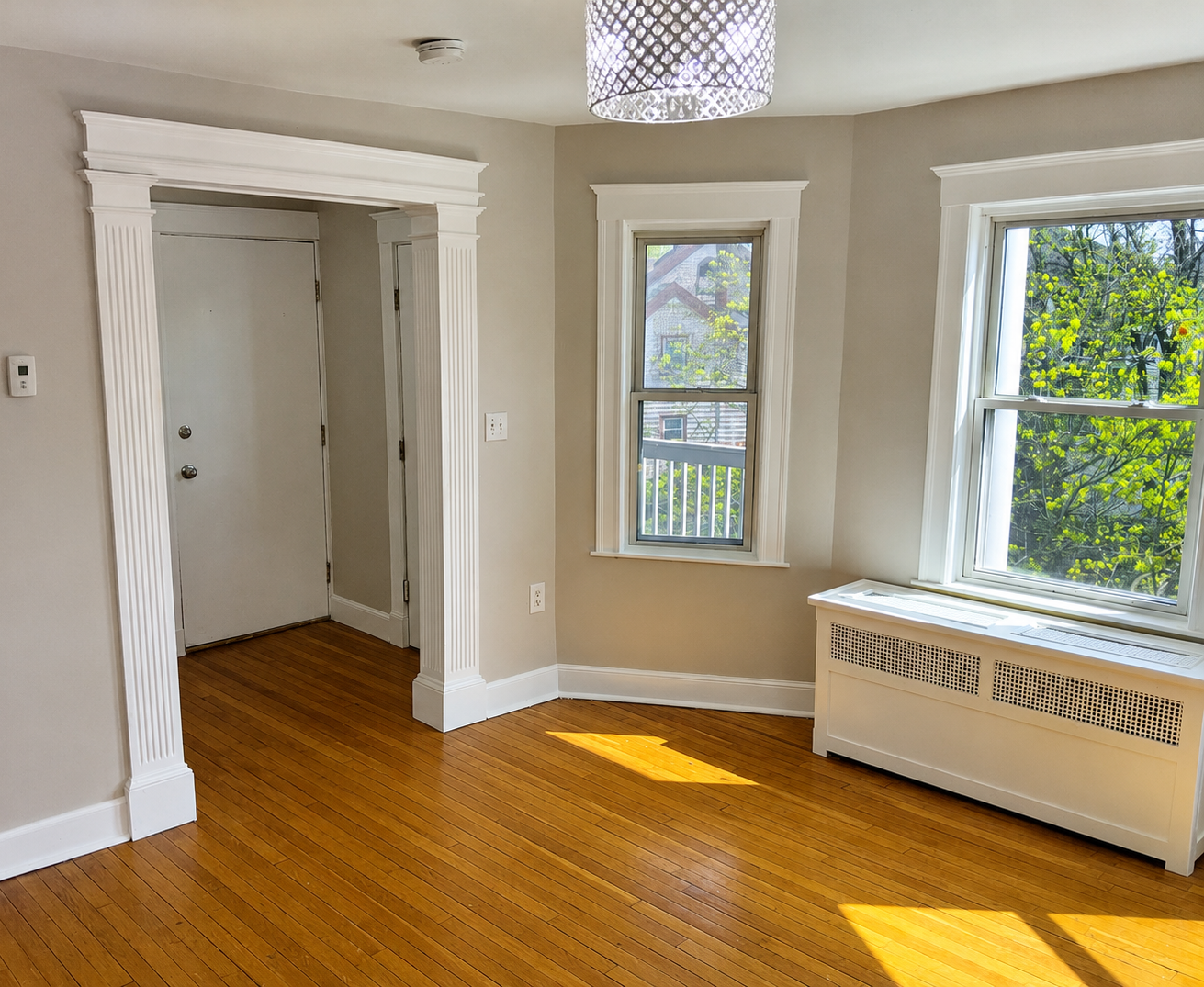 Freshly painted apartment interior with neutral walls, white trim, and hardwood floors in South Shore, Massachusetts
