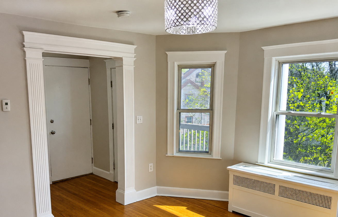 Smooth bedroom walls and detailed white trim professionally painted in South Shore, Massachusetts