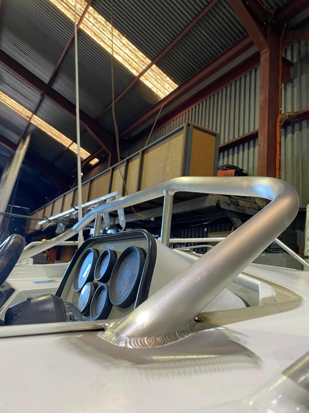 A Car Is Sitting in A Warehouse with A Bar on Top of It — Shearwater Engineering in Taree, NSW