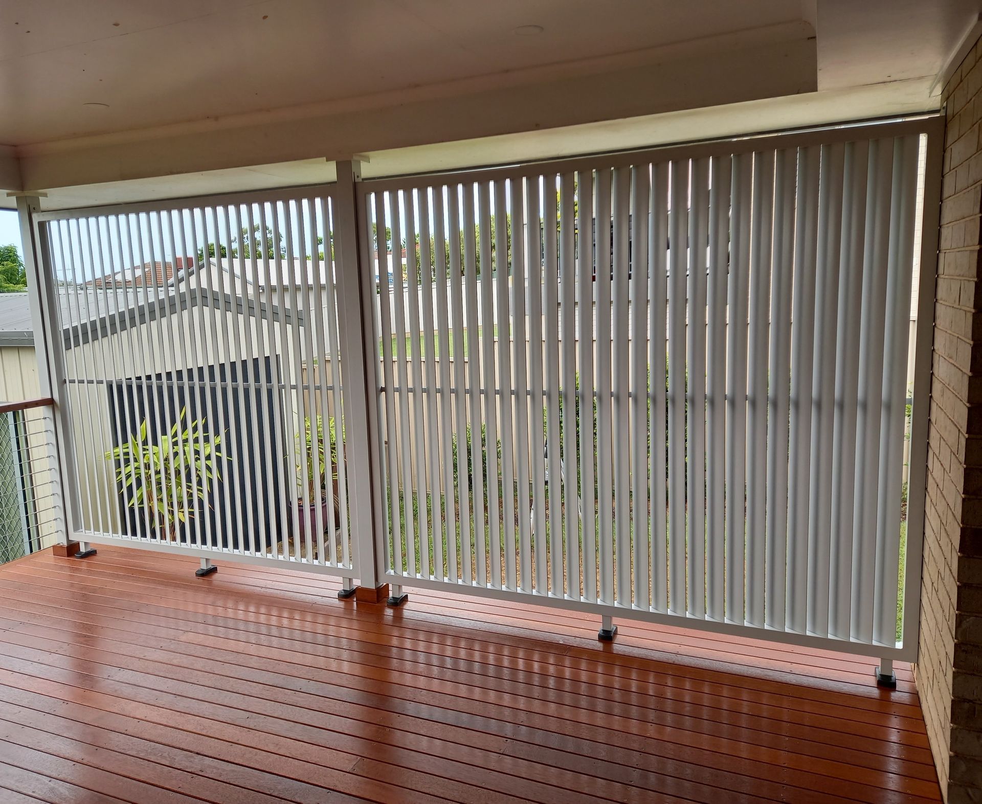 There Is a Fence with Privacy Screens on It and A Lawn in Front of It — Shearwater Engineering in Taree, NSW