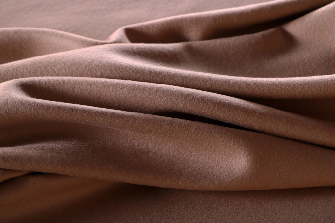 A close up of a piece of brown fabric on a table.