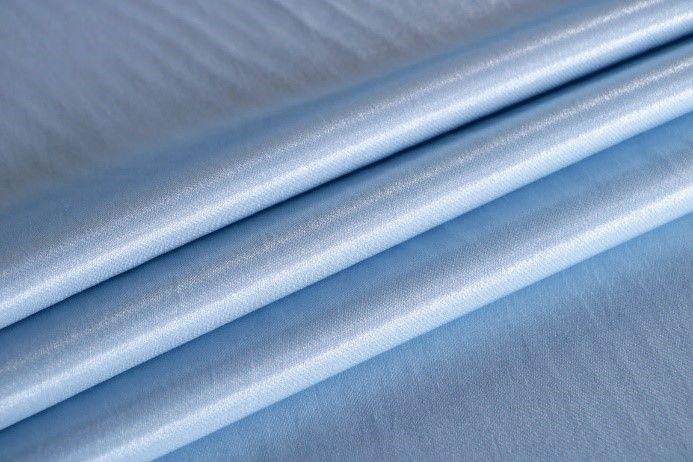 A close up of a piece of light blue fabric.