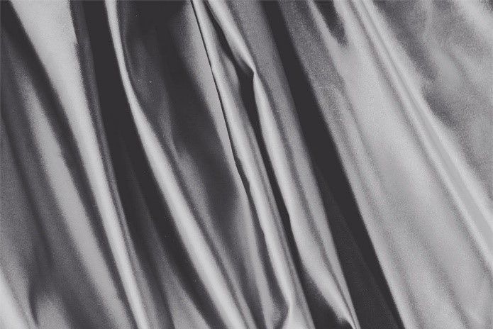 It is a black and white photo of a satin curtain.