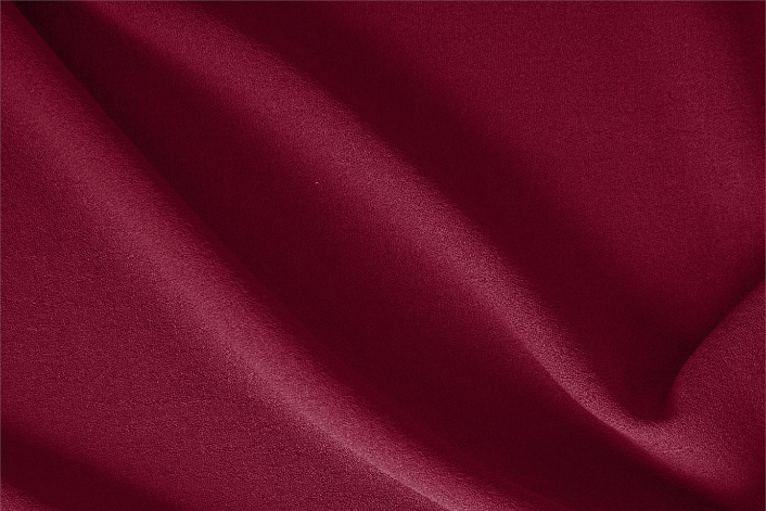 A close up of a piece of red satin fabric.