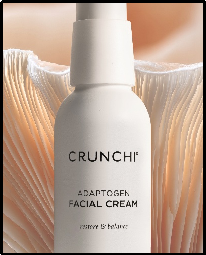Four Crunchi skincare products in white packaging arranged on a neutral background.