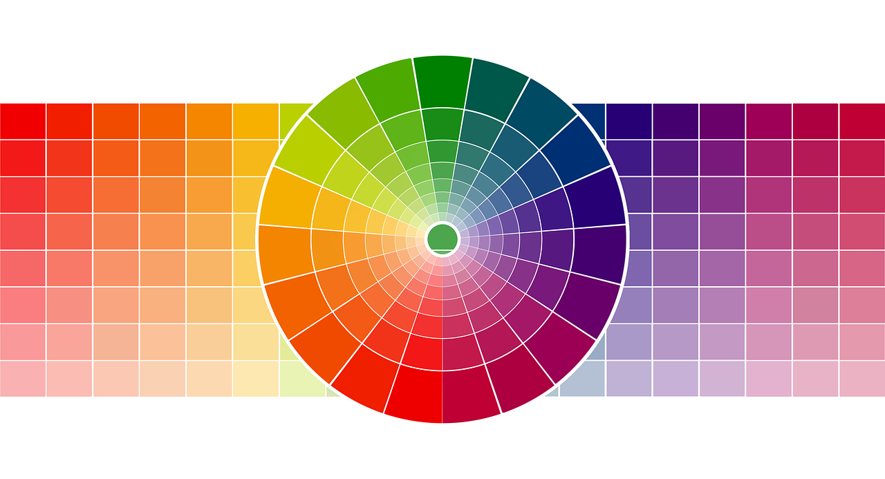 A circular color wheel displaying a spectrum of hues, overlaid on a grid of color swatches fading toward white.
