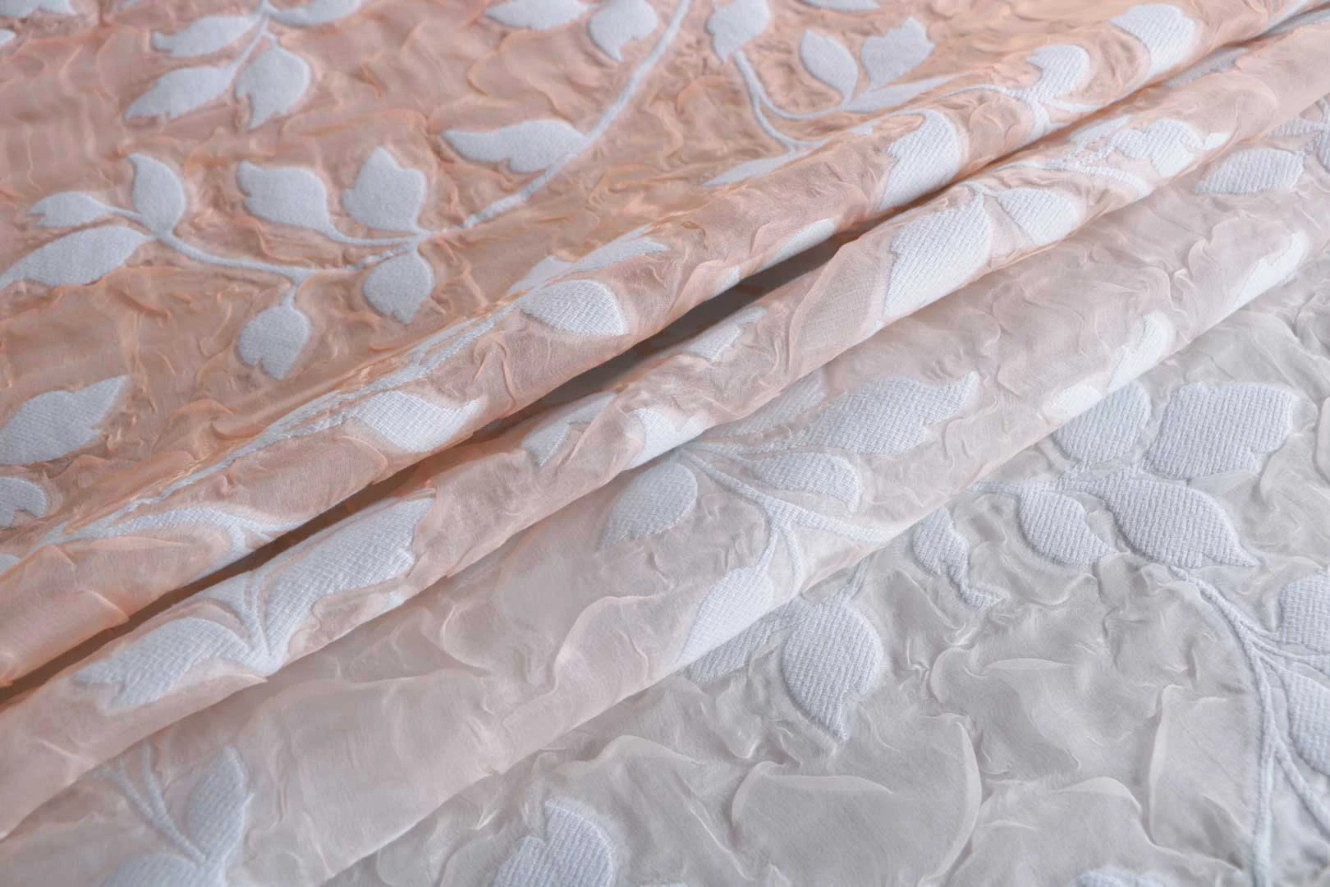A close up of two pieces of fabric with leaves on them.