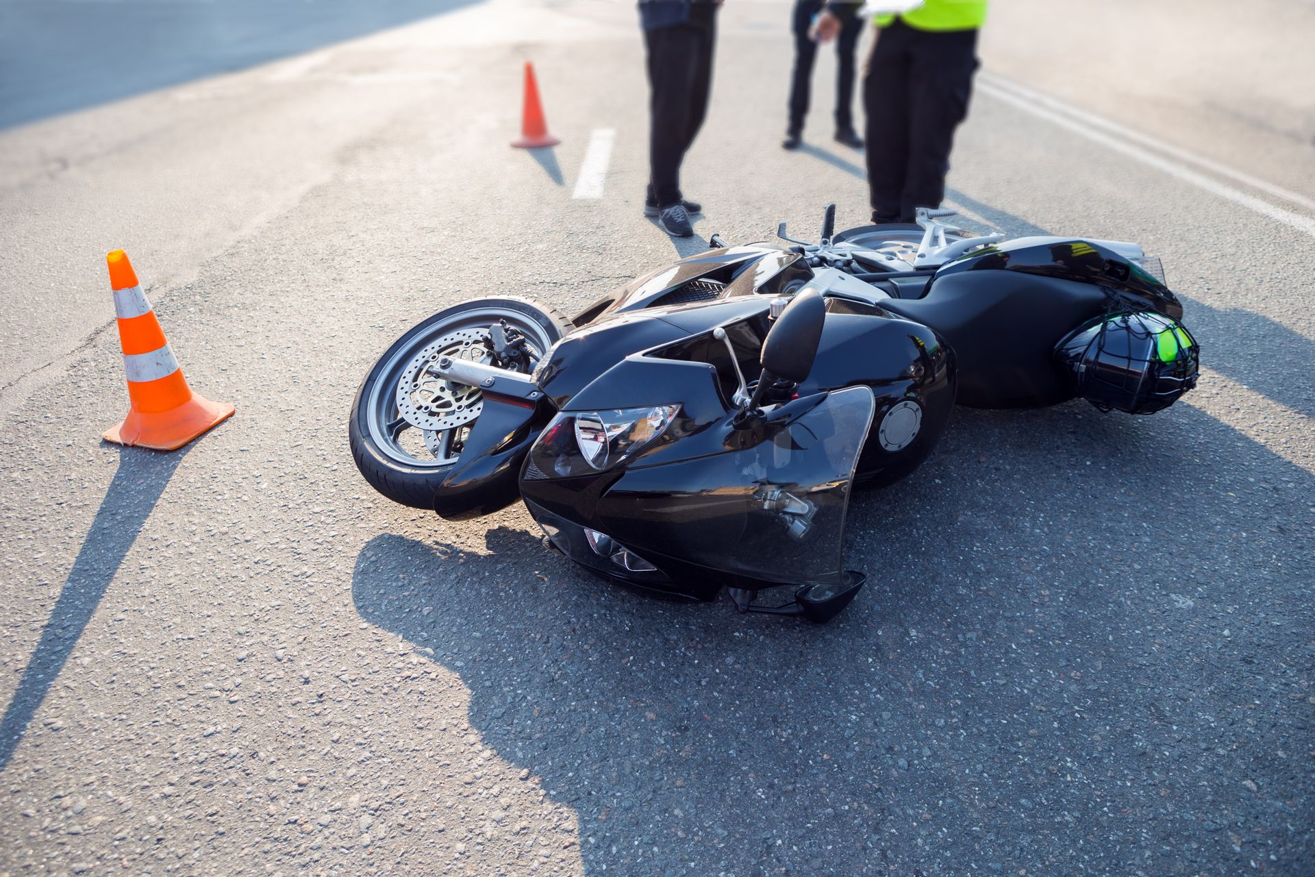 Motorcycle on its side in road after accident.