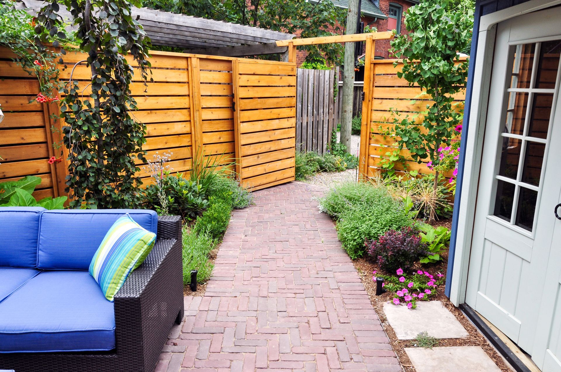 A private entrance to a small urban backyard garden.