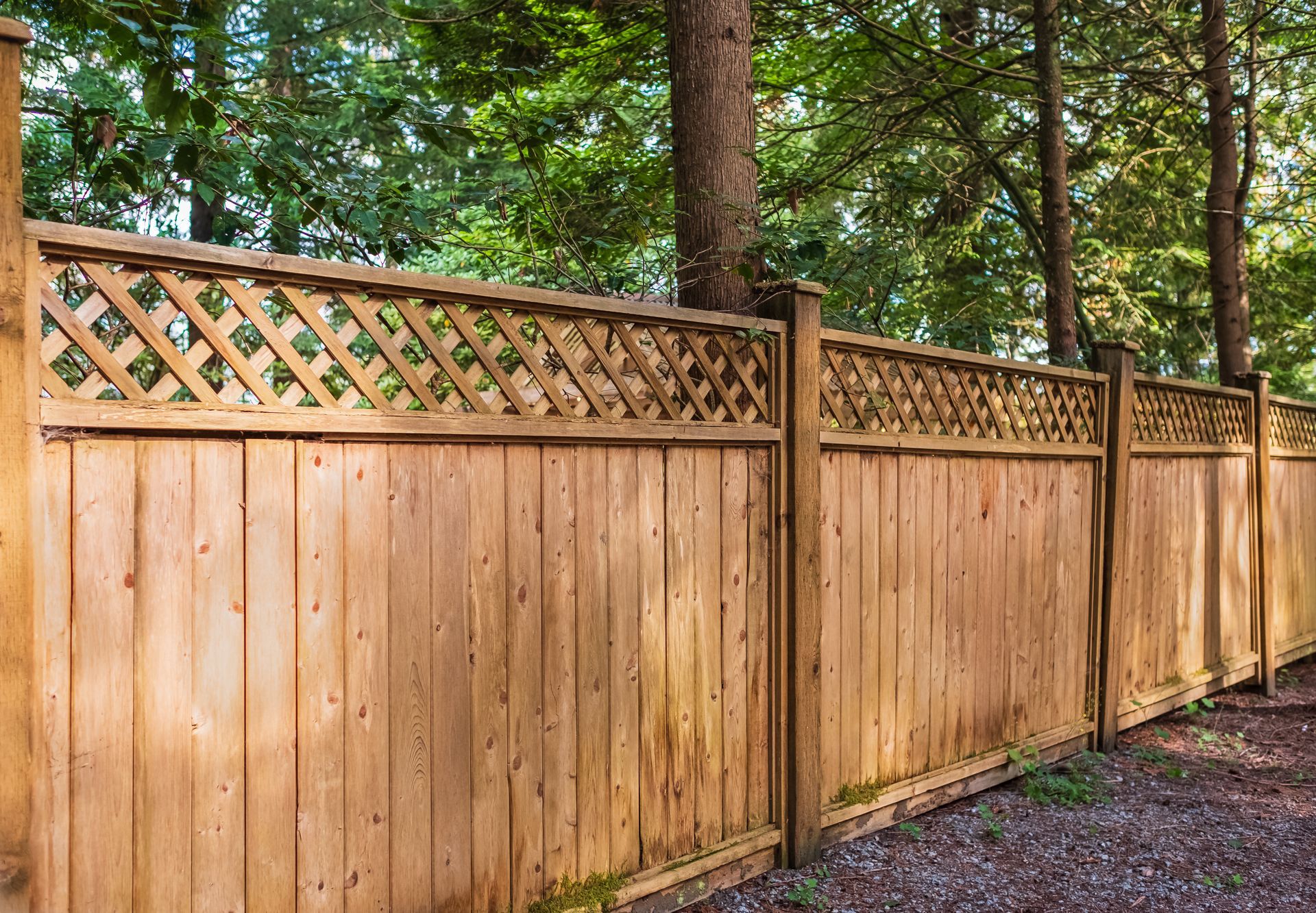 Nice new wooden fence around house.