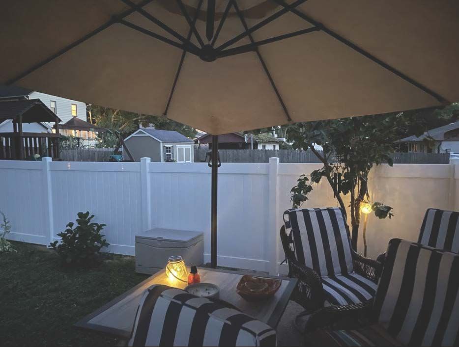 A patio with a table and chairs under an umbrella