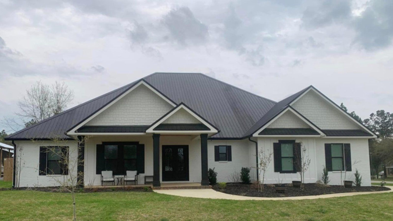 Seamless gutters installed by Southern Gutters on a gray home with a dark roof
