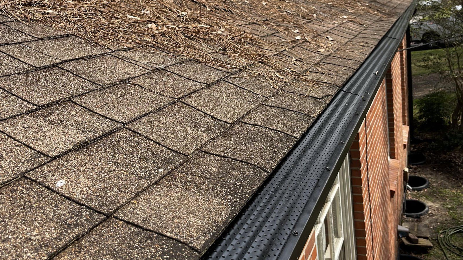 Micro-mesh gutter guard keeping pine straw out of a gutter on a Mobile, AL home