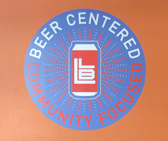 Logo with a soda can and circular text reading “Beer Center Community Focused” on an orange background