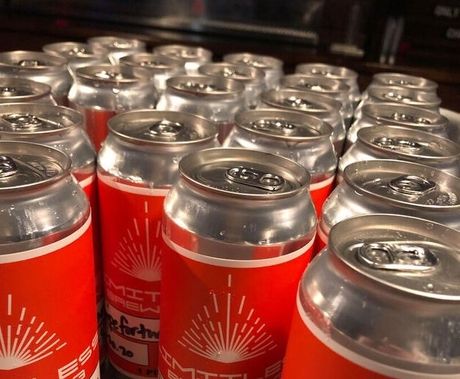 Rows of red aluminum cans stacked tightly together, viewed from above.