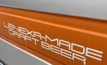 Orange vehicle panel with white text reading “Lenexa-Made Craft Beer”