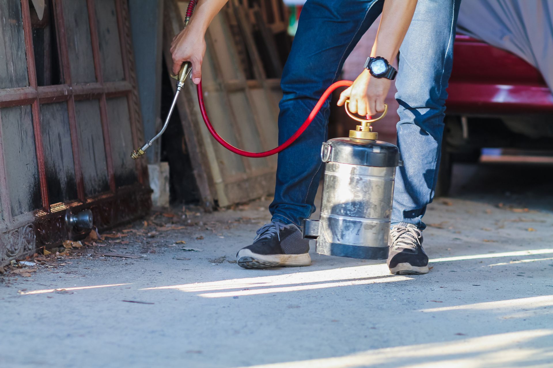 A man is spraying a chemical.