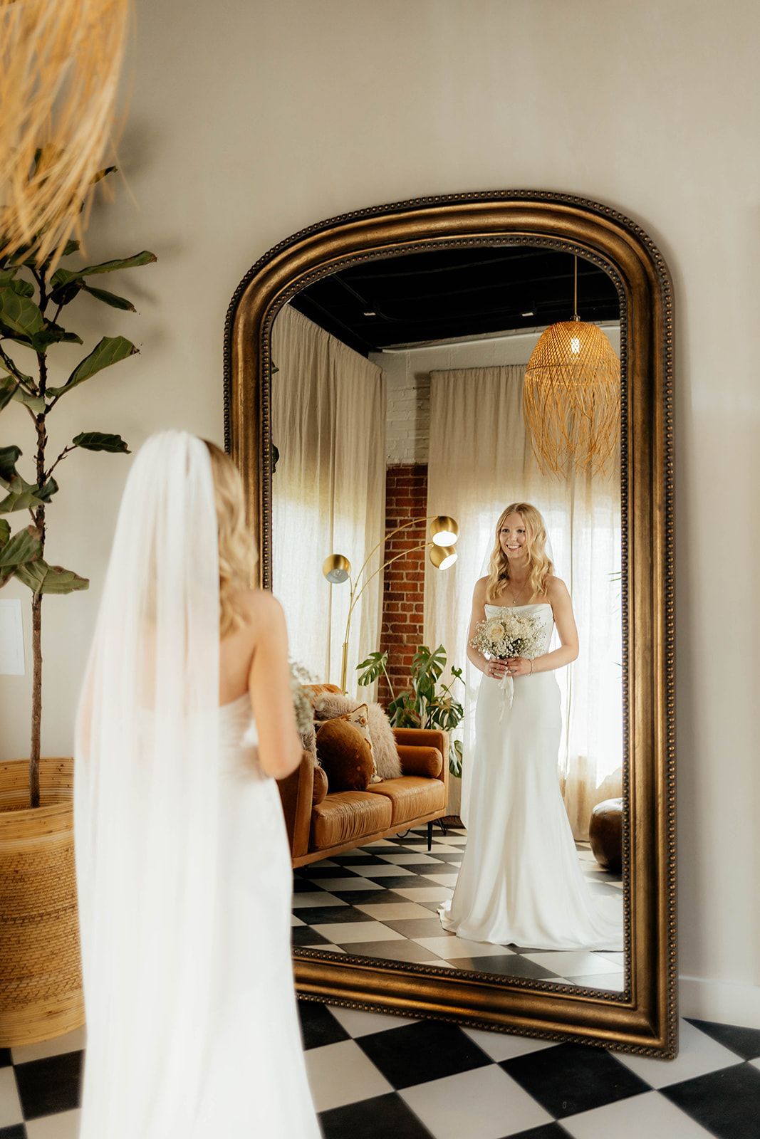 Bride posing in front of mirror at Bestow Events in Longmont, Colorado.