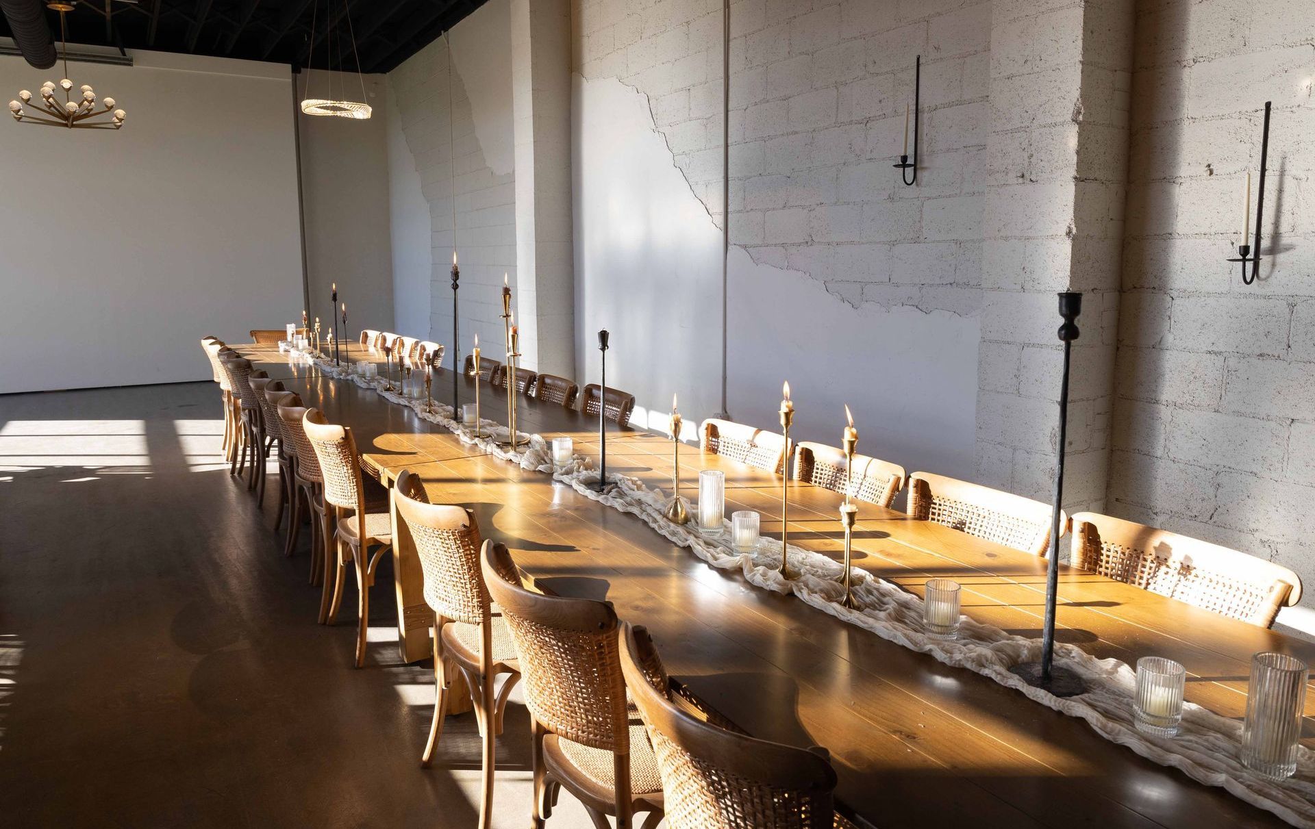 Long farm tables and decor in the main hall at Bestow Events near Boulder, CO.