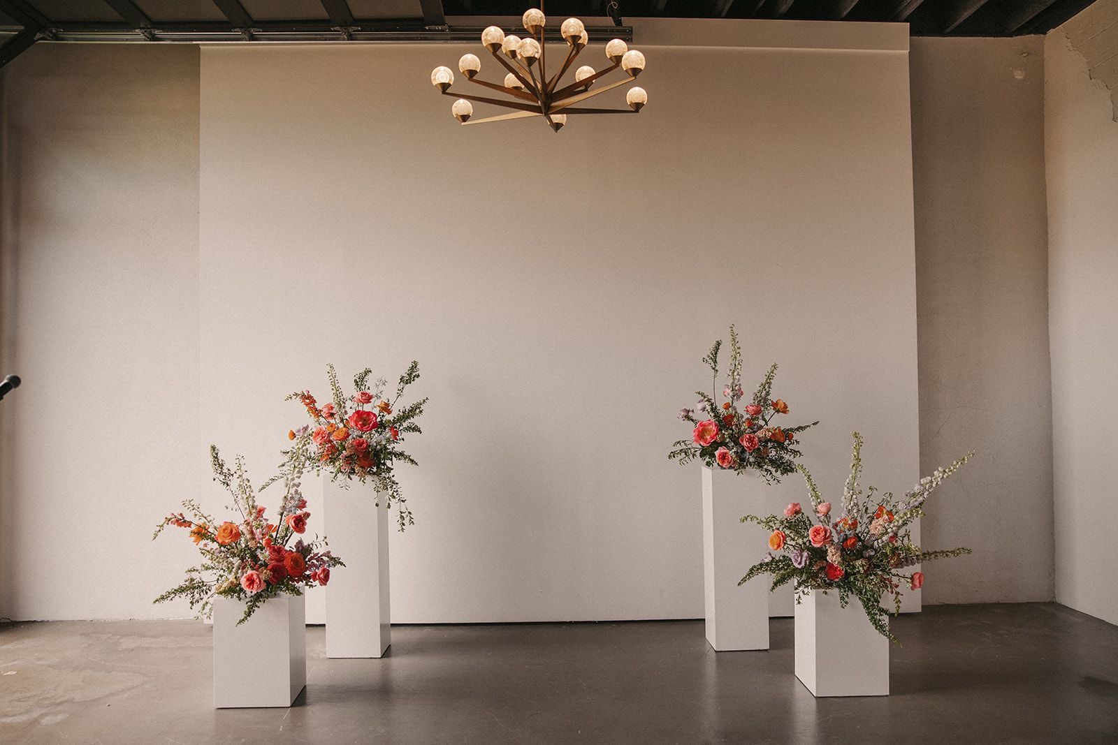 Floral display on top of white pillars at wedding reception space near Boulder, CO.
