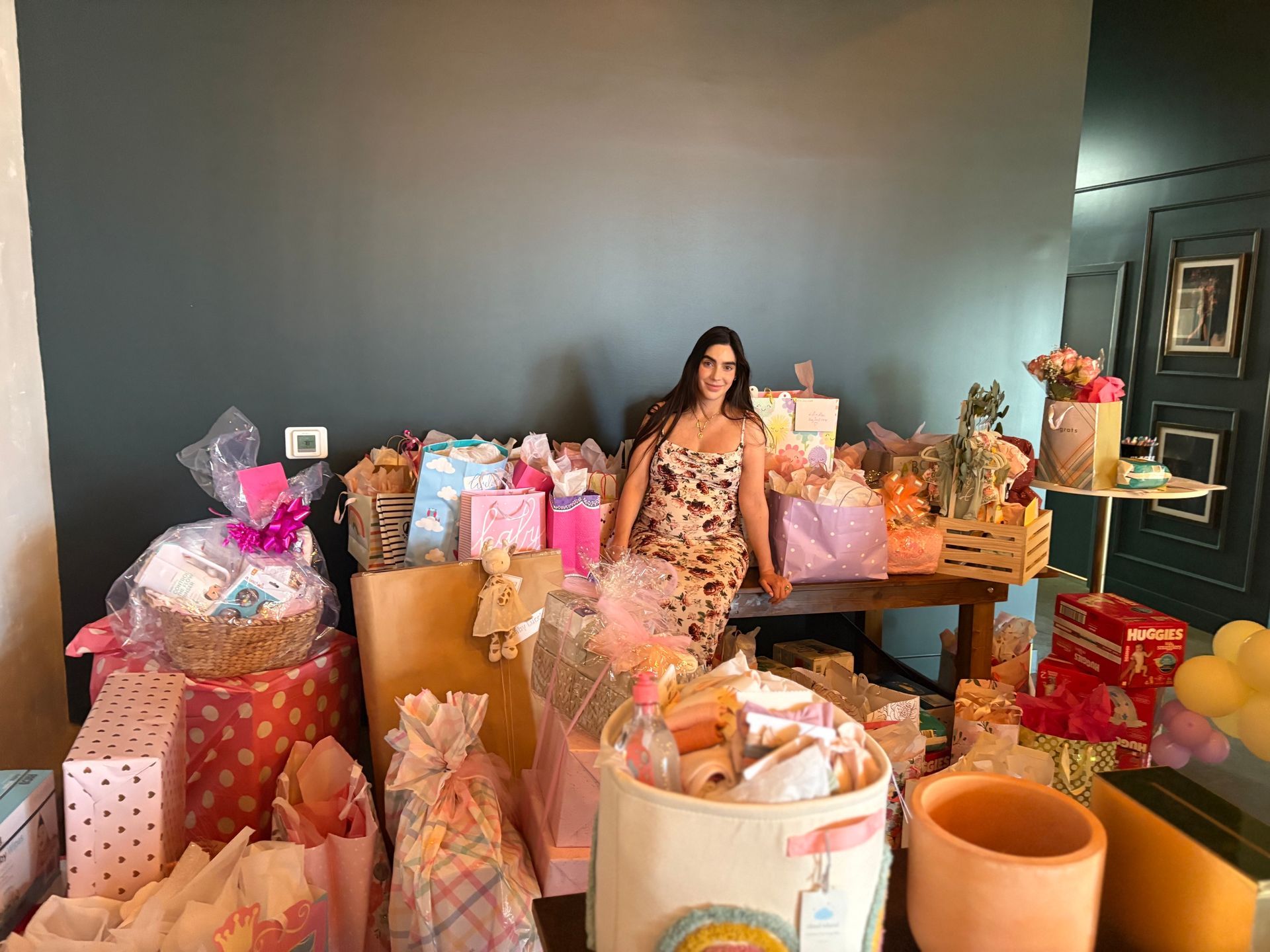 Mom to be with her baby shower presents at Bestow Events in Longmont, CO.