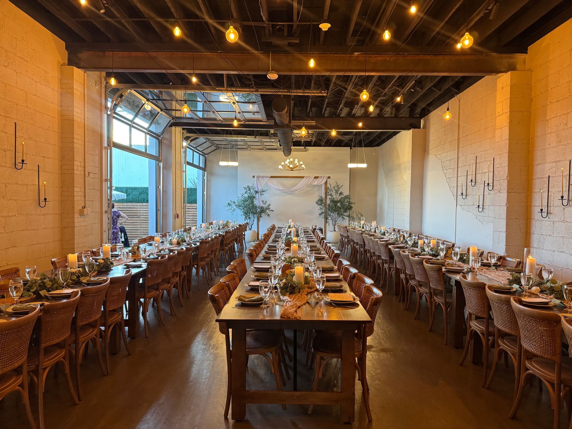 Farm tables set for wedding reception at Bestow Events in Longmont, Colorado.