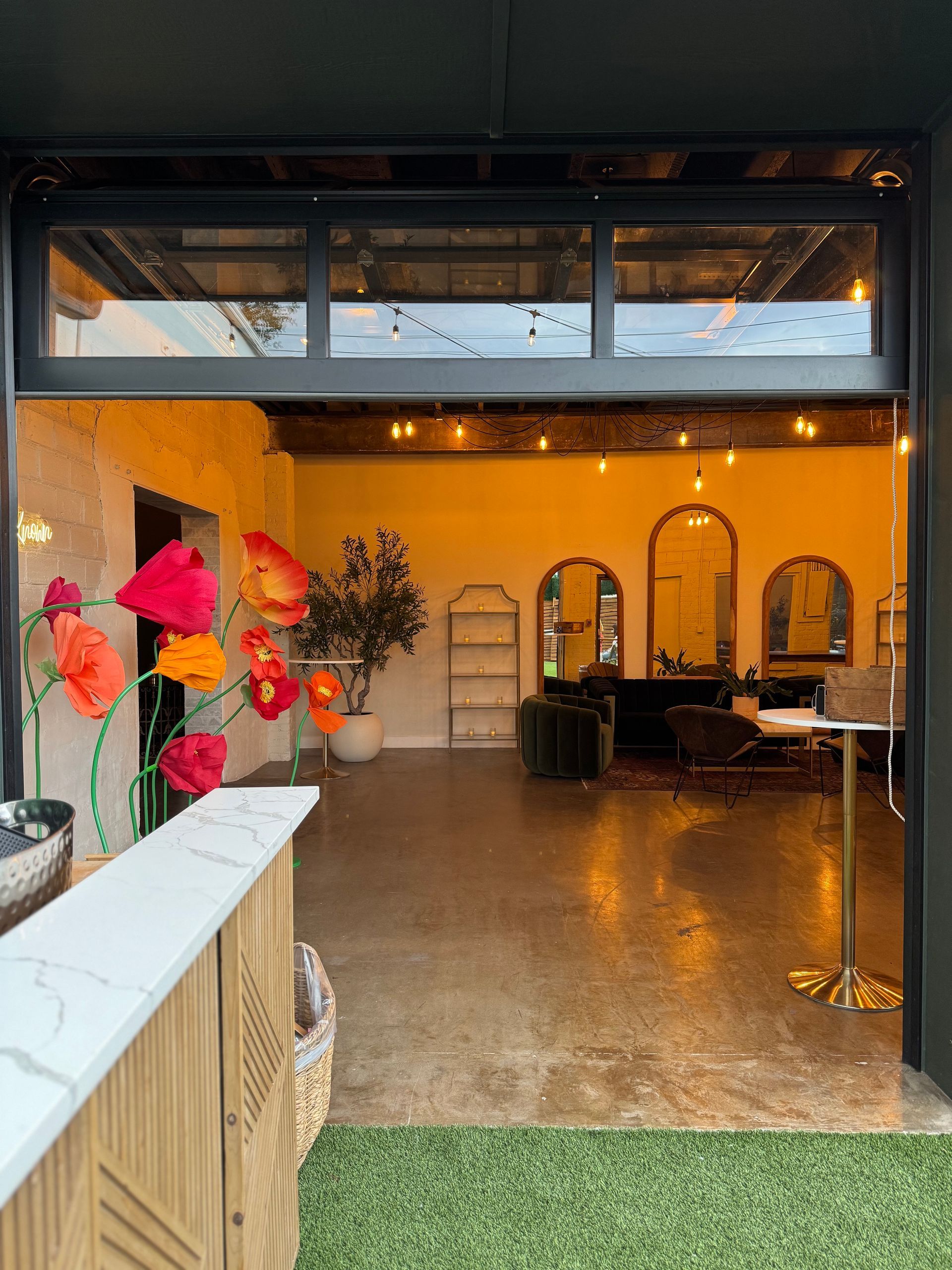View of garage door between indoor and outdoor spaces at Bestow Events in Longmont, Colorado.