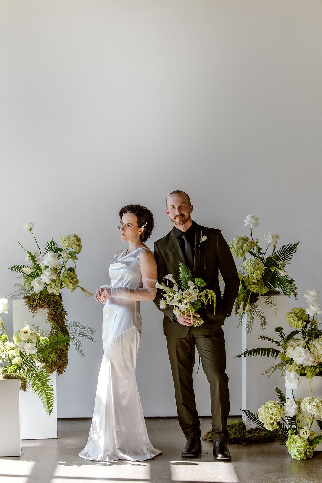 Couple posing around ceremony floral set up at Bestow Events in Longmont, CO.