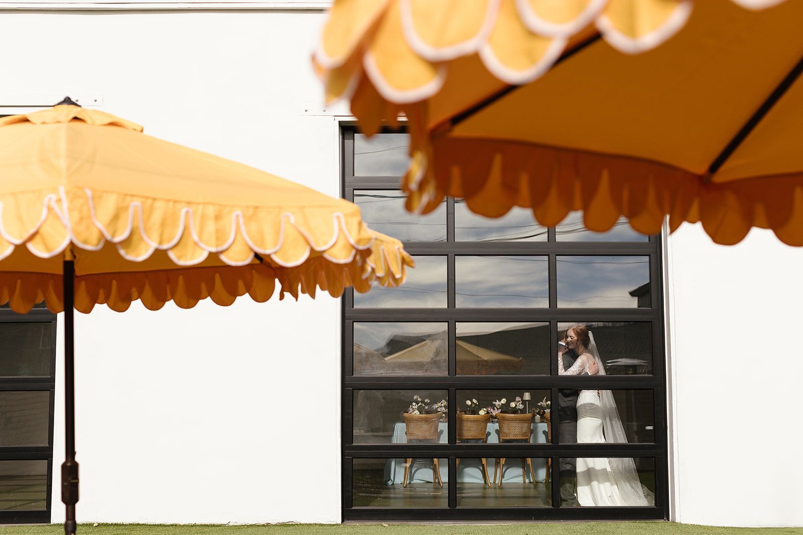 Bride and groom embracing inside of Bestow Events in Longmont, CO.