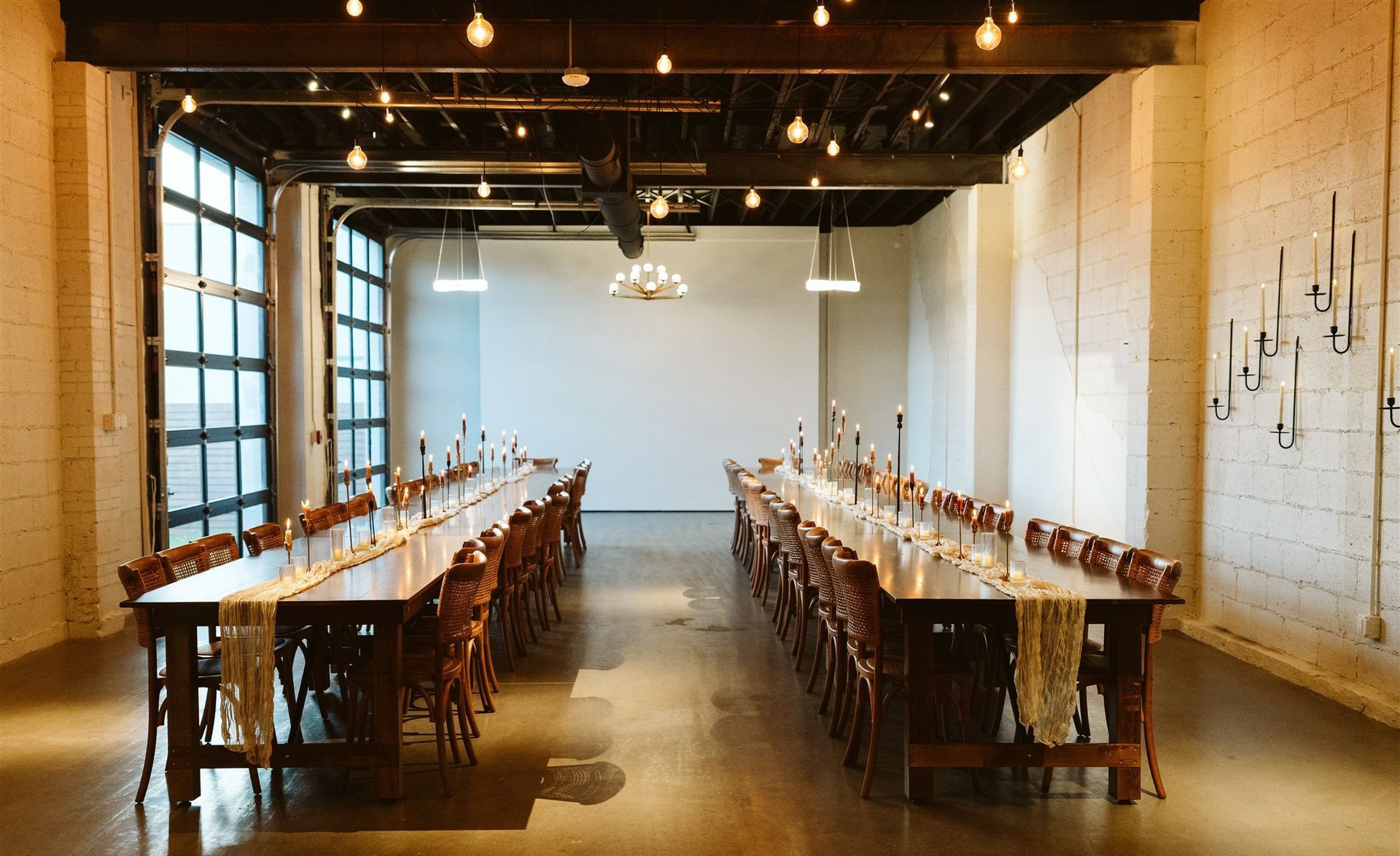 Farm tables set for wedding reception at Bestow Events in Longmont, Colorado.