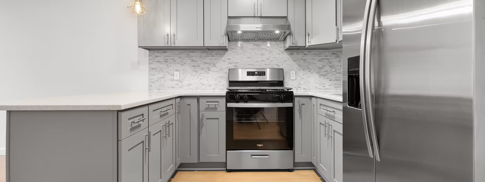 Refrigerator, dishwasher, & oven repair in Fresno CA, modern kitchen with stainless steel appliance.