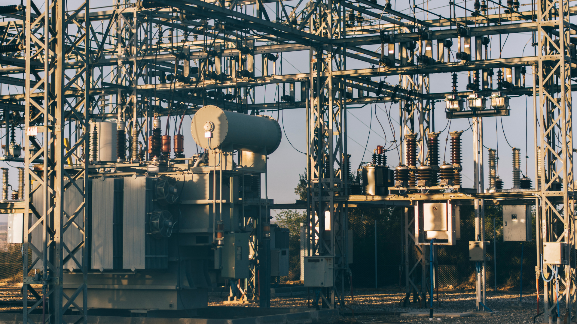 A large electrical substation with a lot of transformers and power lines.
