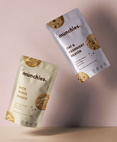 Two bags of munchies cookies are floating in the air.