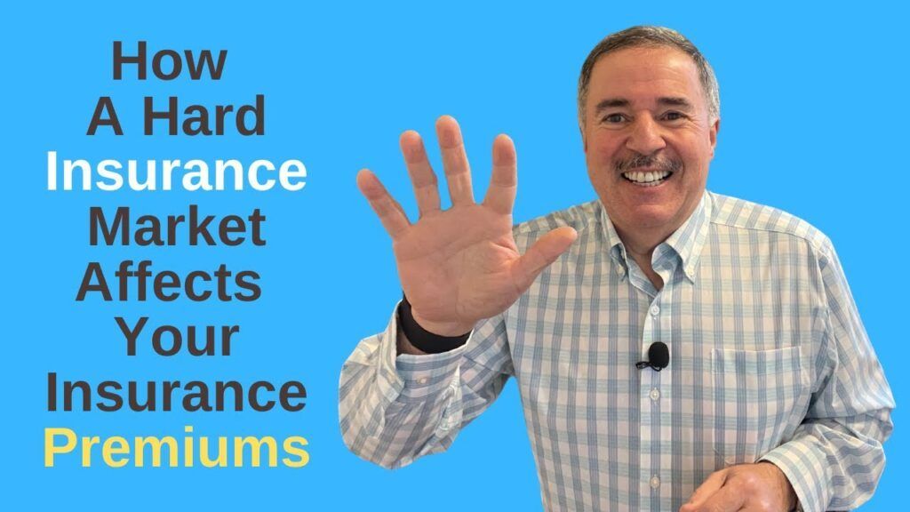Man smiling and waving beside text: “How a Hard Insurance Market Affects Your Insurance Premiums”