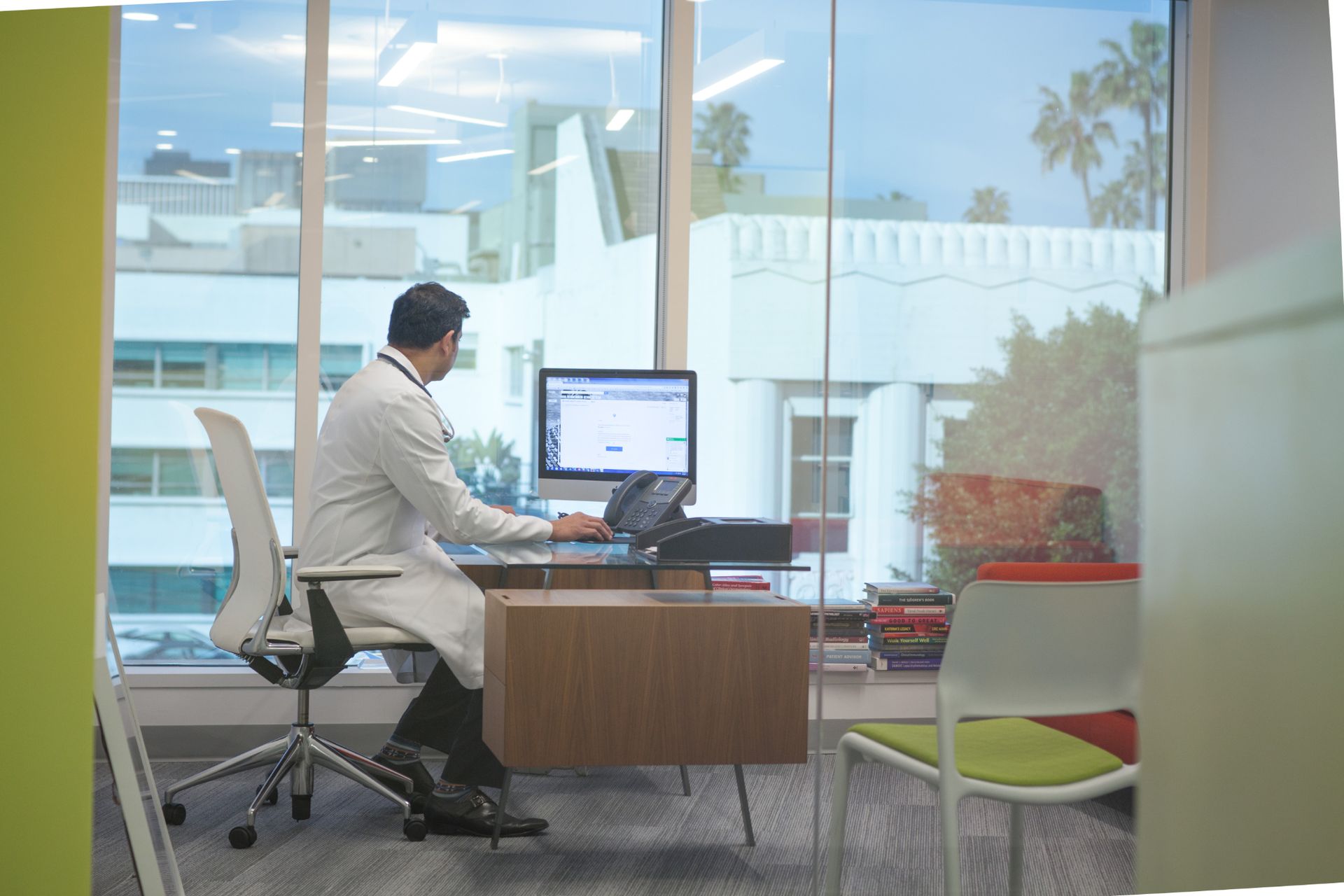 Dr. Swamy Venuturupalli working at computer in his office at Attune Health