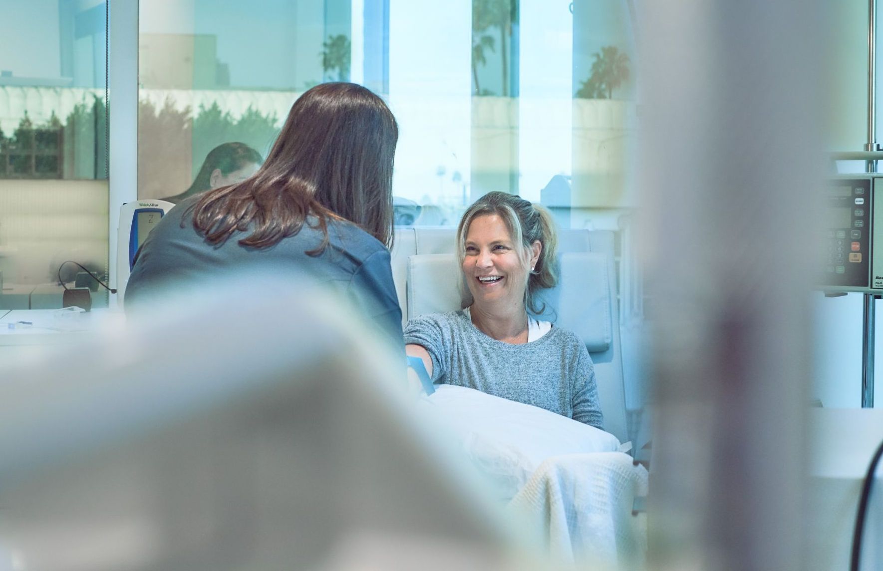 Attune Health nurse assists female infusion patient