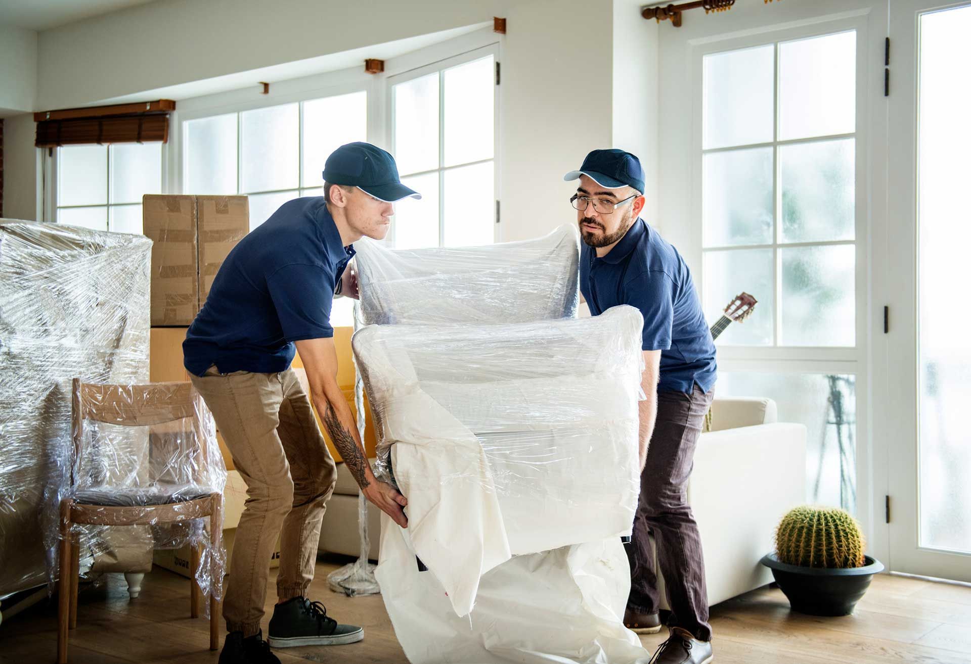 two movers moving a chair