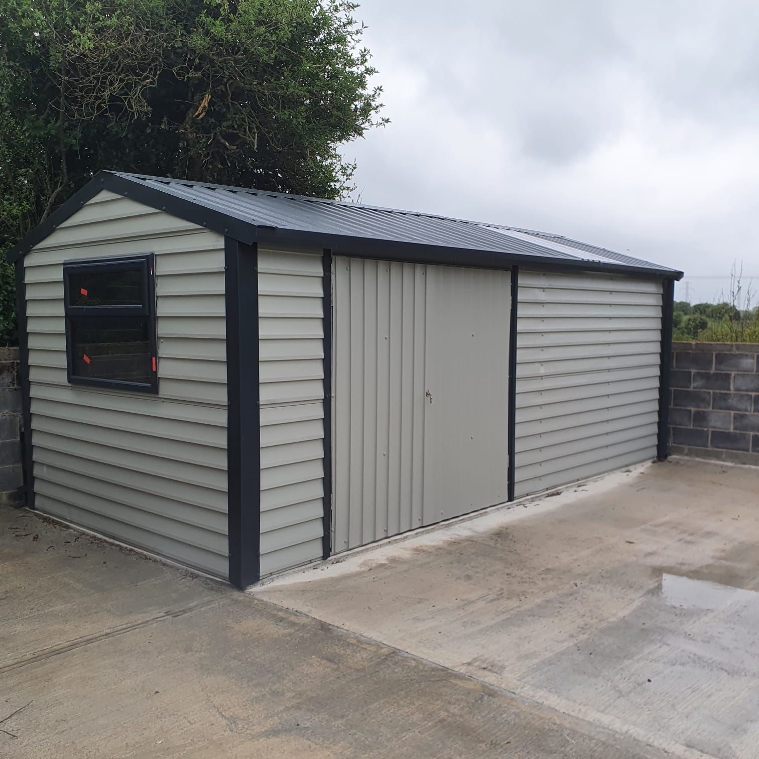 A grey garage with a black trim and a window