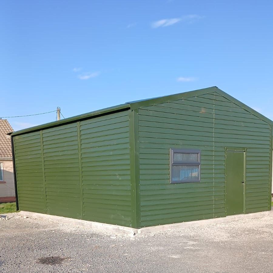 A white garage with a black trim and a blue sky in the background