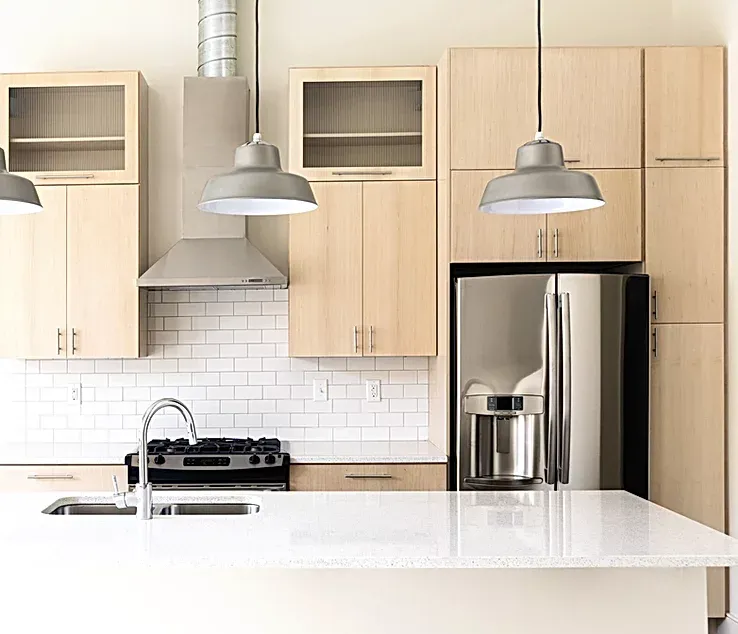A kitchen with wooden cabinets and a white counter top