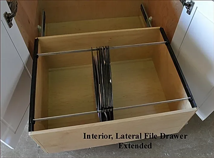 An interior lateral file drawer is extended with metal dividers