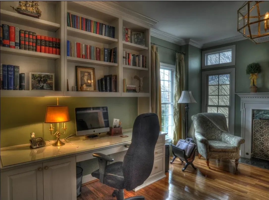 A desk with a computer on it in a living room